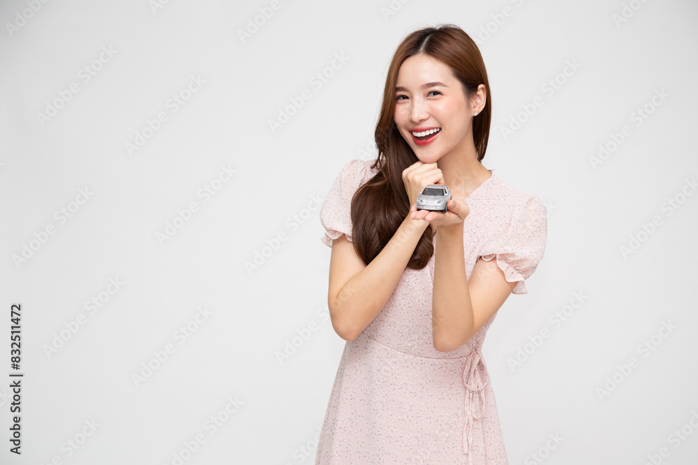 Young Asian woman holding car model isolated on white background, Car Insurance concept Young Asian woman holding car model isolated on white background, Car Insurance concept