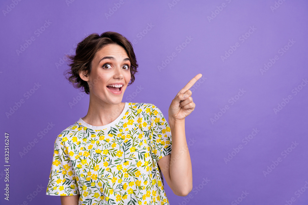 Portrait of pretty young woman direct finger empty space wear t-shirt isolated on purple color background Portrait of pretty young woman direct finger empty space wear t-shirt isolated on purple color background