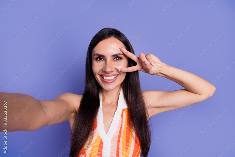 Photo of shiny cheerful lady wear dress tacking selfie showing v-sign cover eye isolated violet color background Photo of shiny cheerful lady wear dress tacking selfie showing v-sign cover eye isolated violet color background