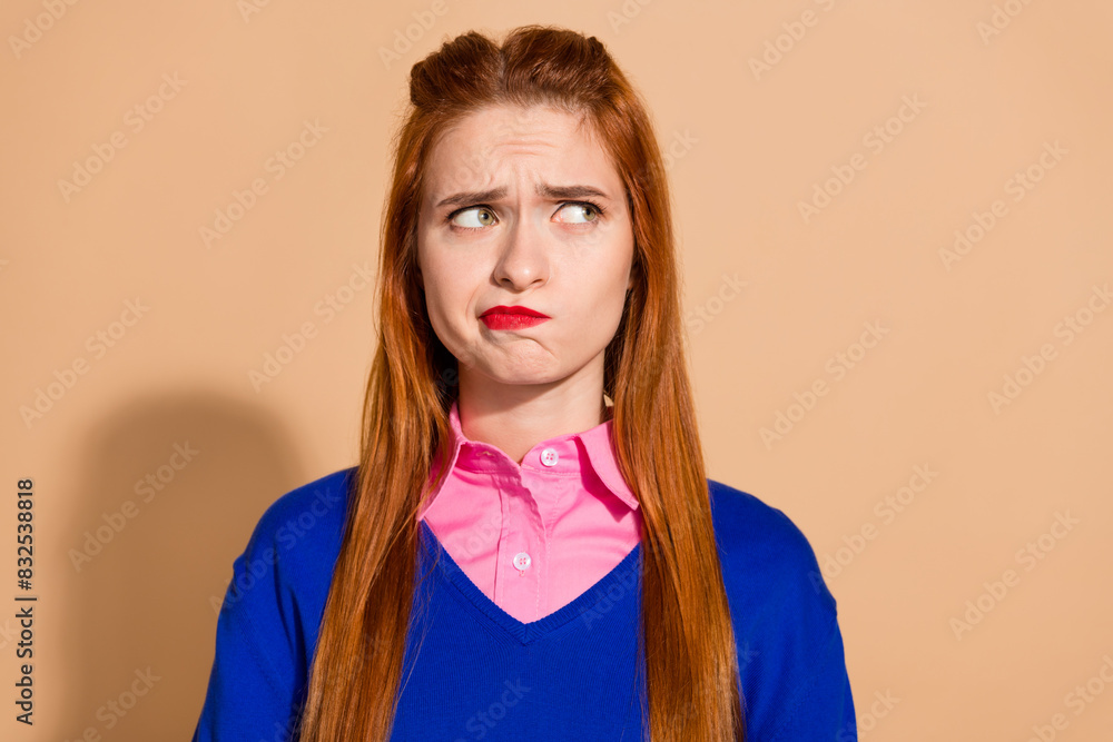 Photo of sweet unsure lady wear sweater looking empty space isolated beige color background Photo of sweet unsure lady wear sweater looking empty space isolated beige color background