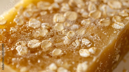 A closeup of a palmsized oatmeal and honey soap bar with a rough texture ideal for gentle exfoliation. photo