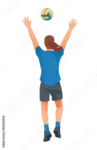 Women's volleyball girl player in a blue T-shirt from the back who jumps straight with her arms raised high to catch or block the ball