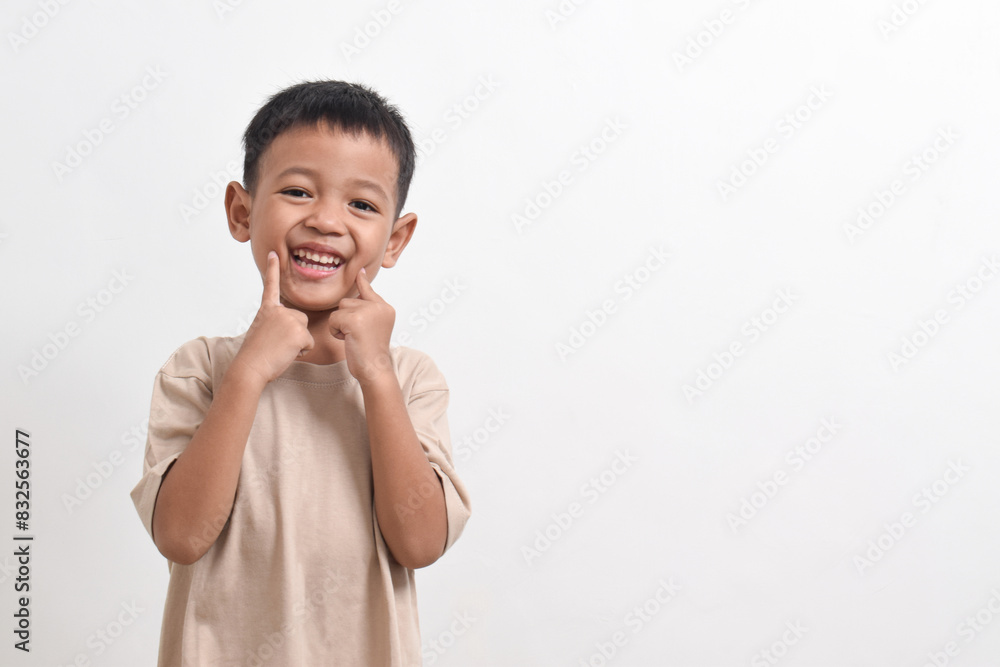 Image of Asian child posing cute and smiling happily on white background. portrait of an Asian boy Image of Asian child posing cute and smiling happily on white background. portrait of an Asian boy
