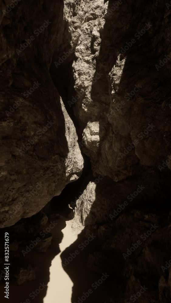 A narrow path between two large rocks in a mysterious cave A narrow path between two large rocks in a mysterious cave
