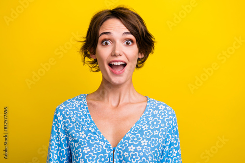 Photo of good mood impressed young lady dressed flower print top open mouth isolated yellow color background