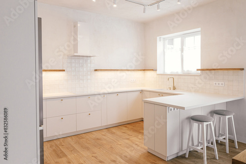 Modern minimal kitchen design. Stylish white kitchen cabinets with brass knobs  faucet  granite island and wooden shelves in new scandinavian house. Modern kitchen interior.