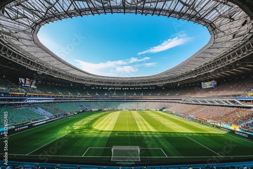 A soccer field with a large crowd of people watching the game