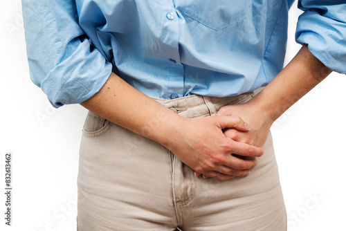 Woman Holds On To The Lower Stomach On The Left Side With Both Hands. Sharp Pain Of Inflammation Of The Appendix.