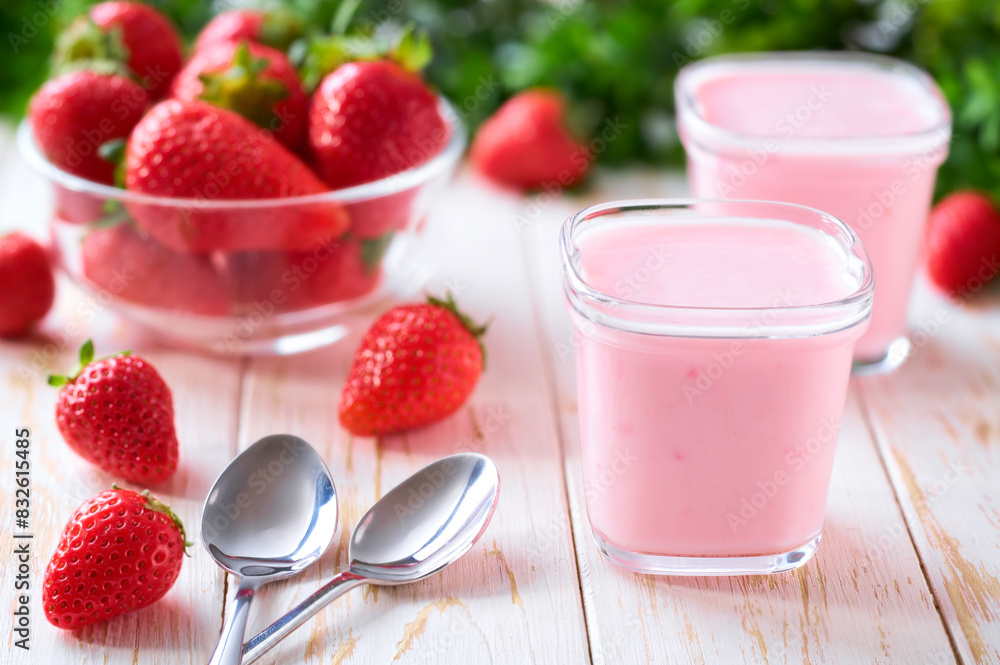 homemade strawberry smoothie in a glass jars with fresh strawberry on a white table, selective focus. homemade strawberry smoothie in a glass jars with fresh strawberry on a white table, selective focus.