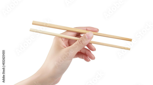 A hand holding wooden chopsticks photo