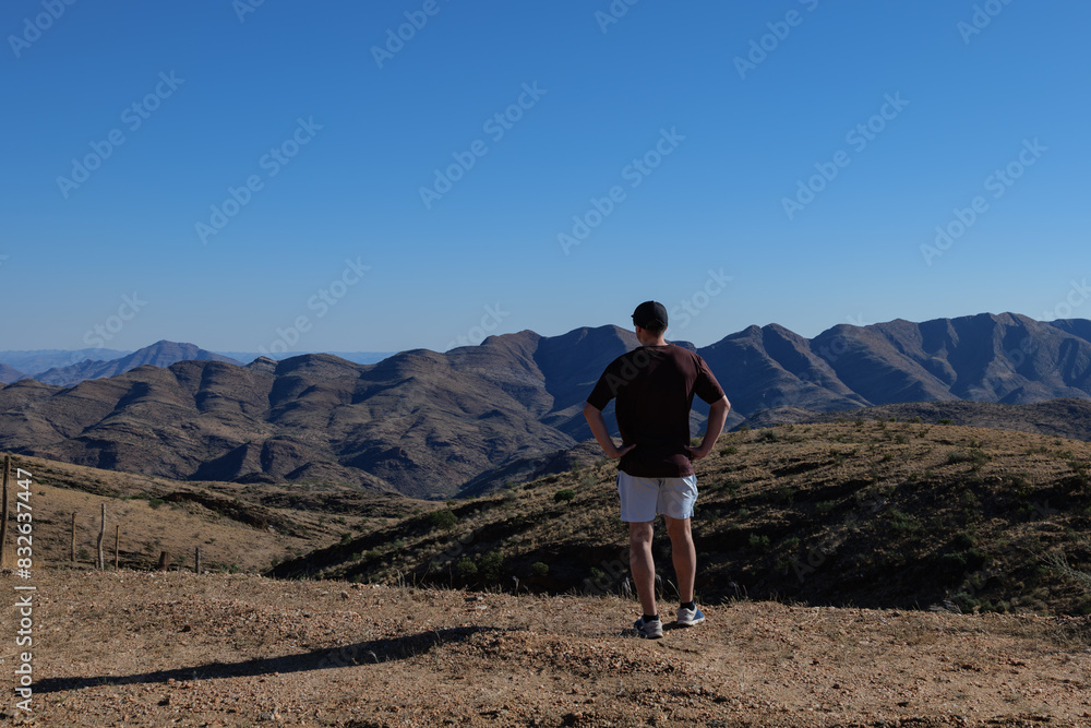 Fototapeta premium Man admiring the Namib Desert, Africa Namibia