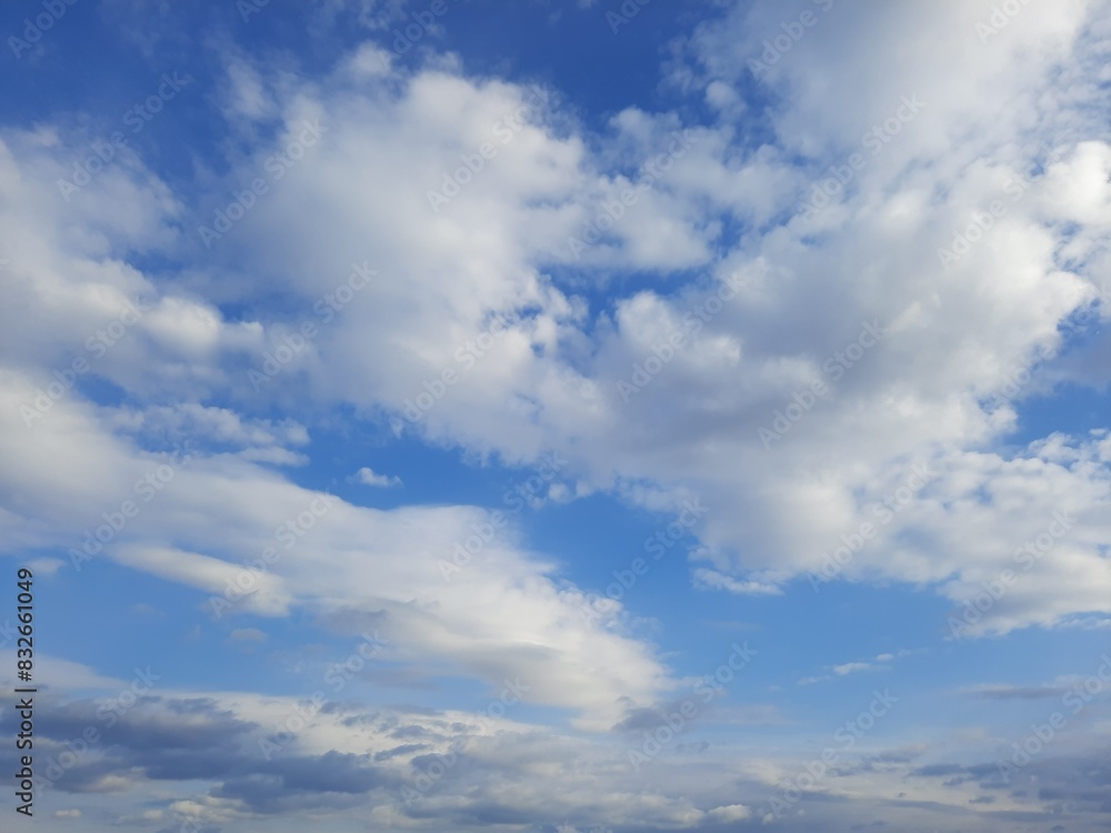 Beauty cloud against a blue sky background. Sky slouds. Blue sky with cloudy weather, nature cloud. White clouds, blue sky and sun. Beauty cloud against a blue sky background. Sky slouds. Blue sky with cloudy weather, nature cloud. White clouds, blue sky and sun.