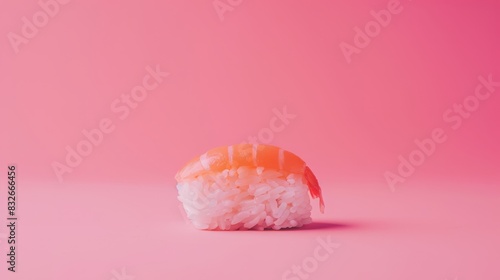  A sushi piece atop pink-hued rice, one bitten, the remainder intact