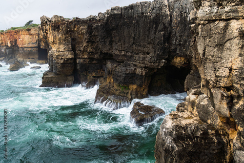 Boca do Inferno (Hell's Mouth) is a unique rock formation on the edge of the ocean in Cascais, Portugal. Cloudy day.