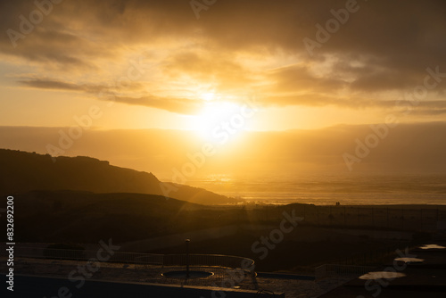 Praia das Maçãs (Apple beach) in Colares, Sintra, Portugal. Sunny day. Sunset. Small town by the sea © Diego