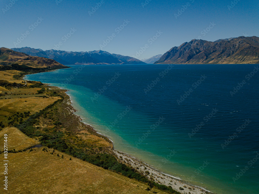 Serene lakeside with mountain backdrop Serene lakeside with mountain backdrop