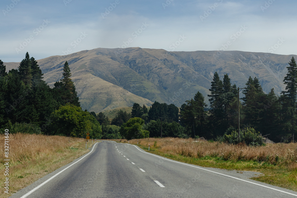 Fototapeta premium Long road leading to distant mountains