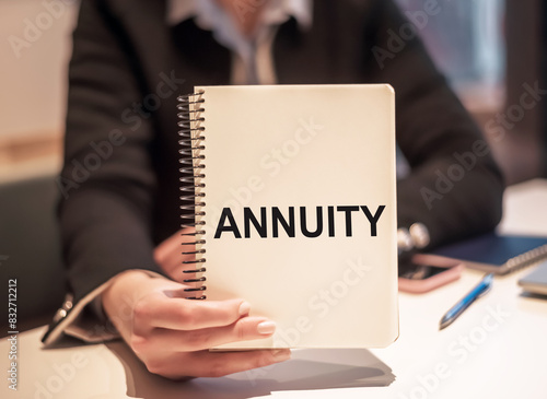 Fotografía Person Holding Notebook With Annuity Written on It