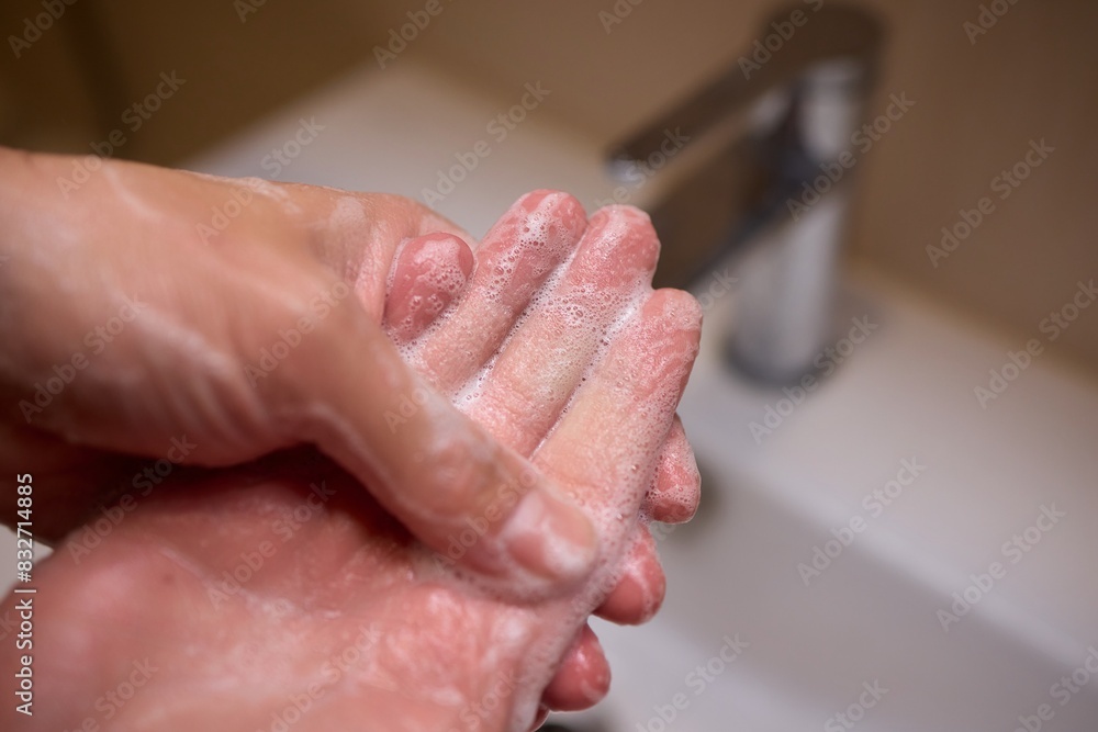 An automatic hand soap dispenser creates foam, promoting hygiene and cleanliness An automatic hand soap dispenser creates foam, promoting hygiene and cleanliness