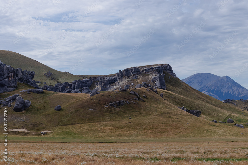 Hills with Rock Outcrops and Mountains Castle Hill New Zealand Travel Summer Outside Day Hills with Rock Outcrops and Mountains Castle Hill New Zealand Travel Summer Outside Day