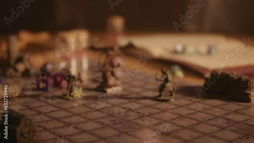 A person playing a tabletop roleplaying game with dice and miniatures