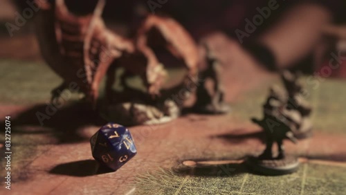 A person playing a tabletop roleplaying game with dice and miniatures