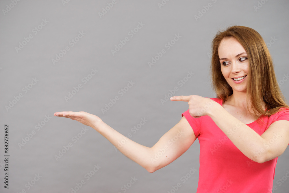 Woman points to open empty hand Woman points to open empty hand