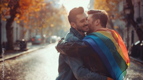 Celebrating Unity: gay men Embrace, Swathed in Rainbow Flag's Glorious Spectrum. Homosexual couple photo