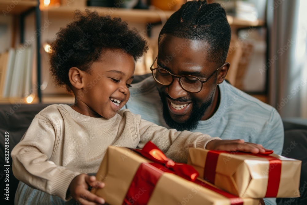 father giving and receiving gifts with his son child on Christmas. Diverse black family on holiday season, Father's Day. father giving and receiving gifts with his son child on Christmas. Diverse black family on holiday season, Father's Day.