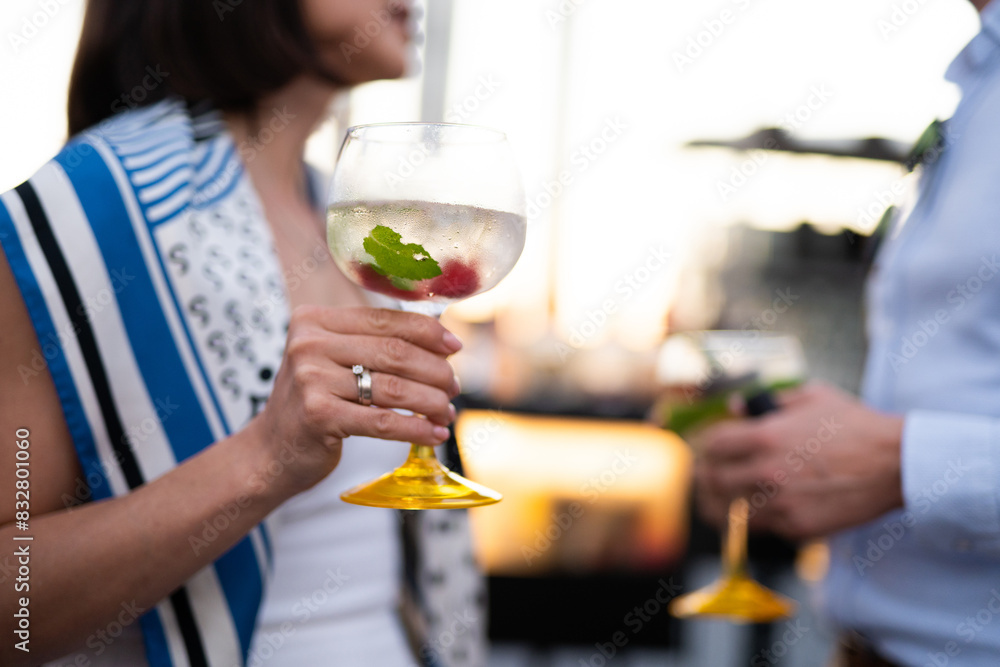 holding cool fresh alcoholic cocktail in hands at party holding cool fresh alcoholic cocktail in hands at party