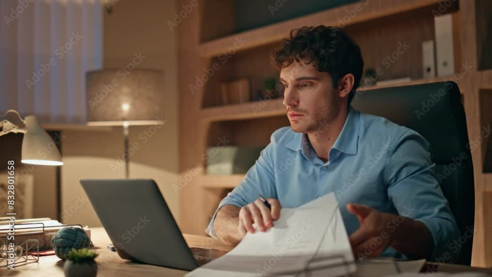 Late worker typing laptop busy of overtime work close up. Man holding documents Late worker typing laptop busy of overtime work close up. Man holding documents