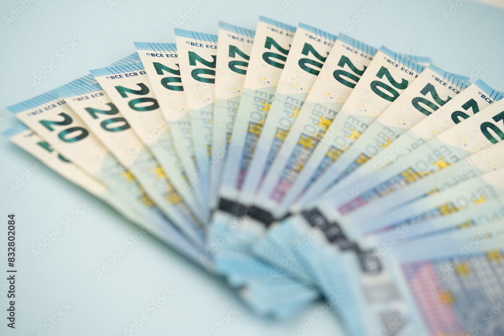 many 20 euro bills on a blue background many 20 euro bills on a blue background