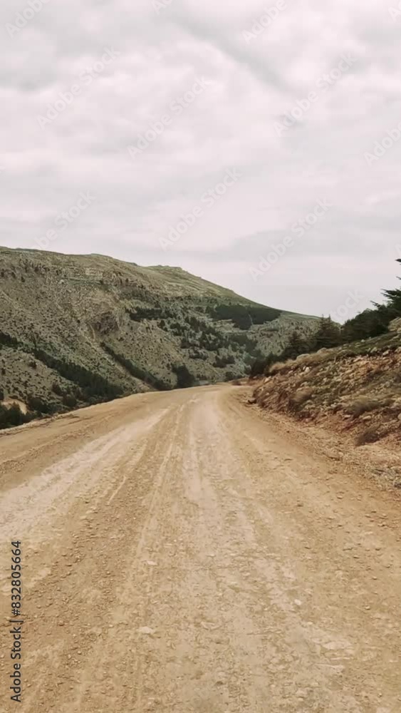 First-person view along highland road through mountain pass. Scenic drive captures mountain road amidst natural surroundings. Video shows journey on mountain road, revealing landscapes First-person view along highland road through mountain pass. Scenic drive captures mountain road amidst natural surroundings. Video shows journey on mountain road, revealing landscapes