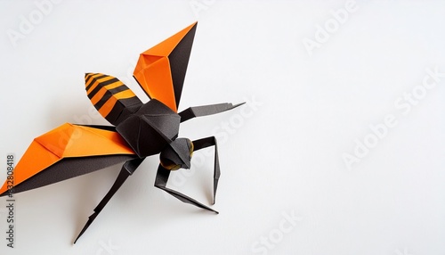 Animal concept origami isolated on white background of an Asian, northern, Japanese or giant hornet - Vespa mandarinia - the largest wasp in the world. with copy space, simple starter craft for kids photo