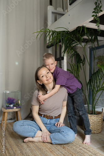 Mother and son bonding with a fish tank at home photo