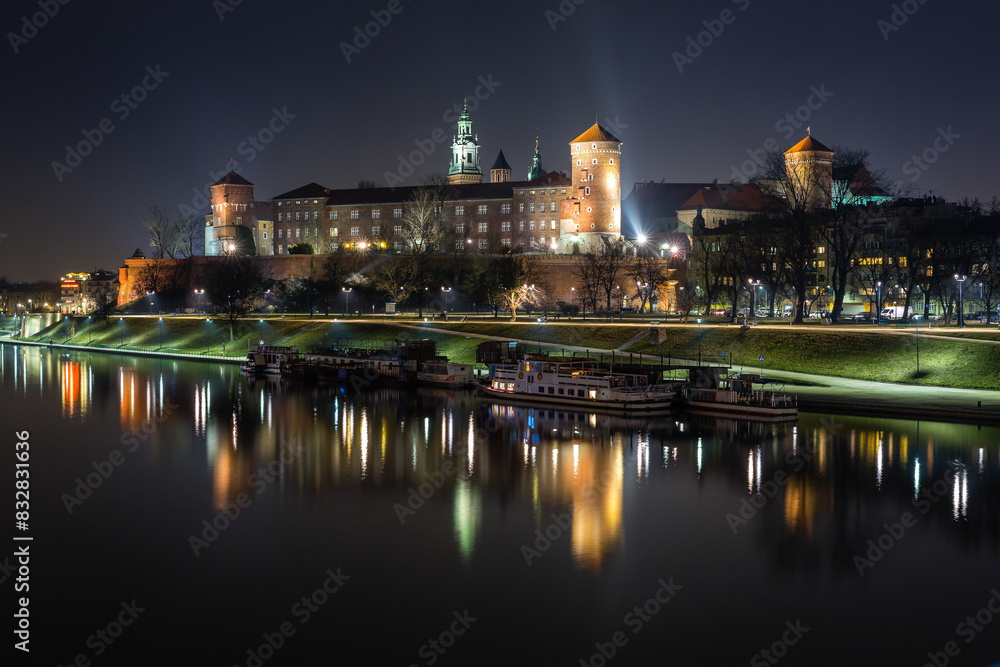 Majestic night view of riverside castle and boats