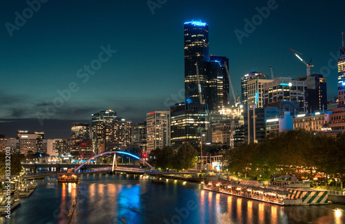 Captivating view of melbourne's city lights reflected in the yarra river at dusk photo