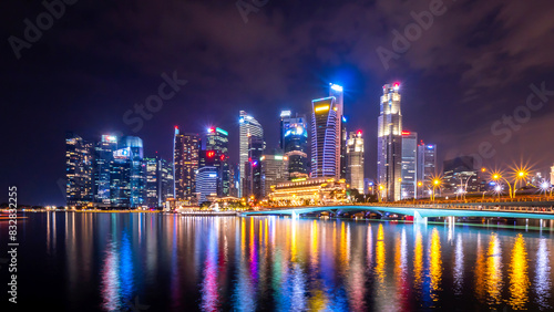 Dazzling city skyline at night with reflective waterfront © Bryan