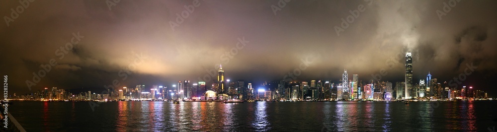 Panoramic night skyline of bustling city harbor