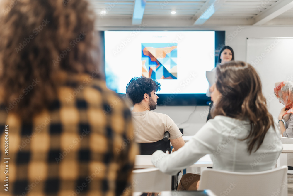 Presenting analytical report at modern conference room. Multicultural group of businesspeople listening to a successful businesswoman giving a speech Presenting analytical report at modern conference room. Multicultural group of businesspeople listening to a successful businesswoman giving a speech