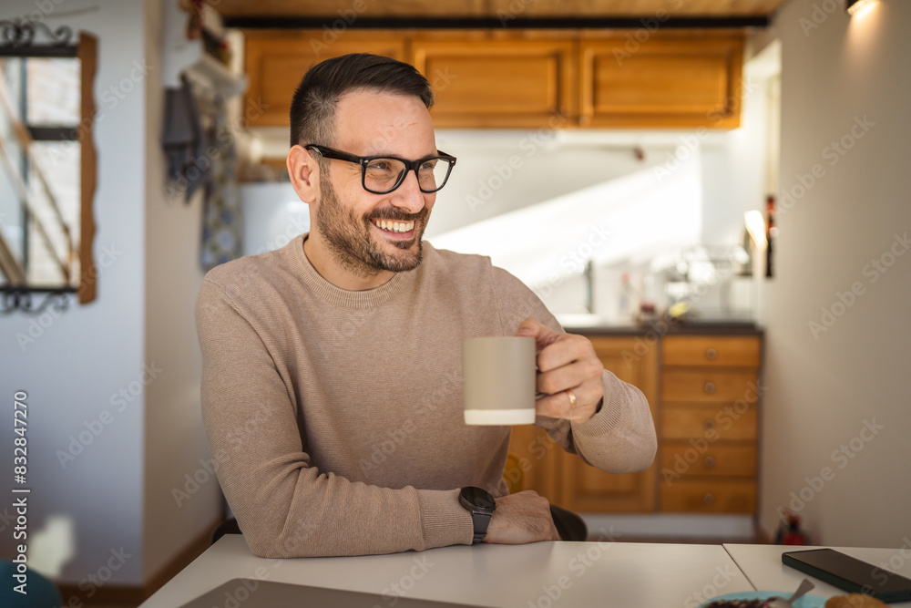 Portrait of adult caucasian man sit at home and hold cup of coffee Portrait of adult caucasian man sit at home and hold cup of coffee