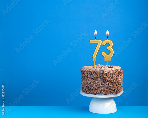 Birthday cake with candle 73 - Invitation card on blue background