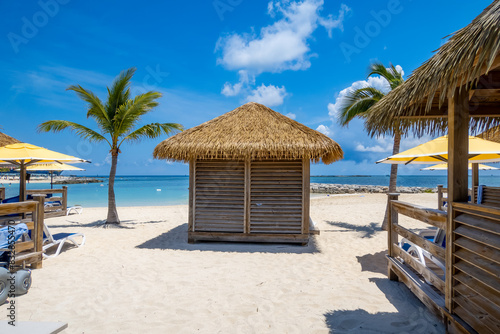Cabanas on white sand beach in Caribbean islands during day time.
