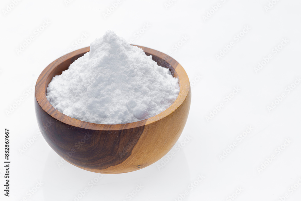 Baking soda in wooden container, isolated on white Baking soda in wooden container, isolated on white