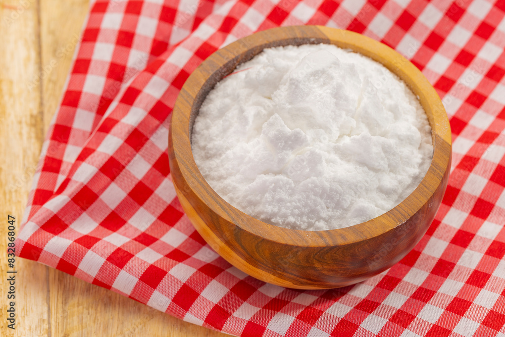 Baking soda in wooden bowl on table Baking soda in wooden bowl on table