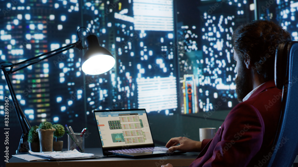 Rich executive director admiring skyscraper view at night, working after hours to improve company financial situation. Professional business expert looking for ways to expand globally.