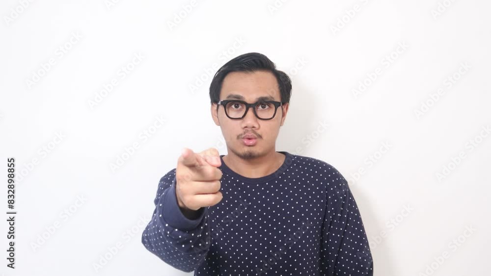 Who do you think you are. Studio shot of a handsome young man pointing a finger in anger against a white background. Who do you think you are. Studio shot of a handsome young man pointing a finger in anger against a white background.