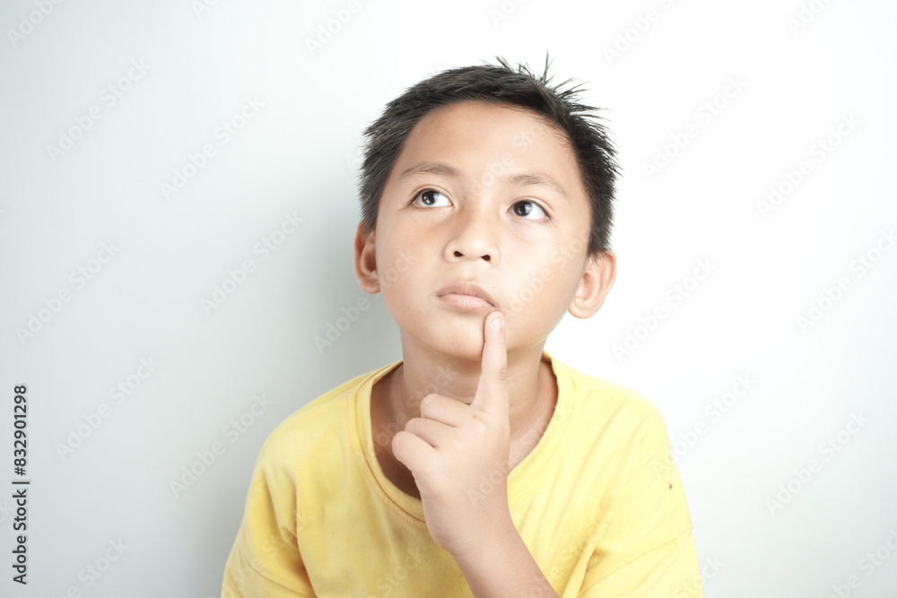Asian boy with thinking expression isolated on white Asian boy with thinking expression isolated on white