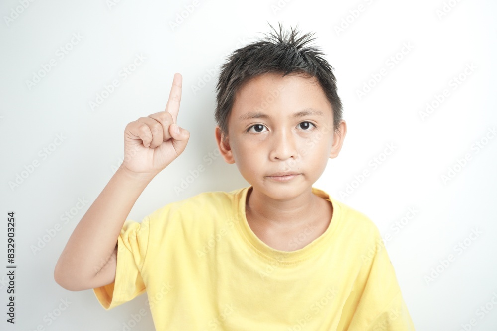 asian boy over isolated white background pointing to the side to present a product asian boy over isolated white background pointing to the side to present a product