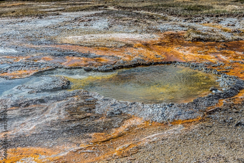 Bubbling lake with a central orange substance and vibrant orange hues Bubbling lake with a central orange substance and vibrant orange hues